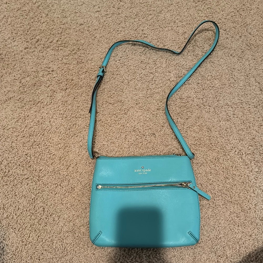 Teal Kate Spade cross body purse. Polka dot inside. Good condition.